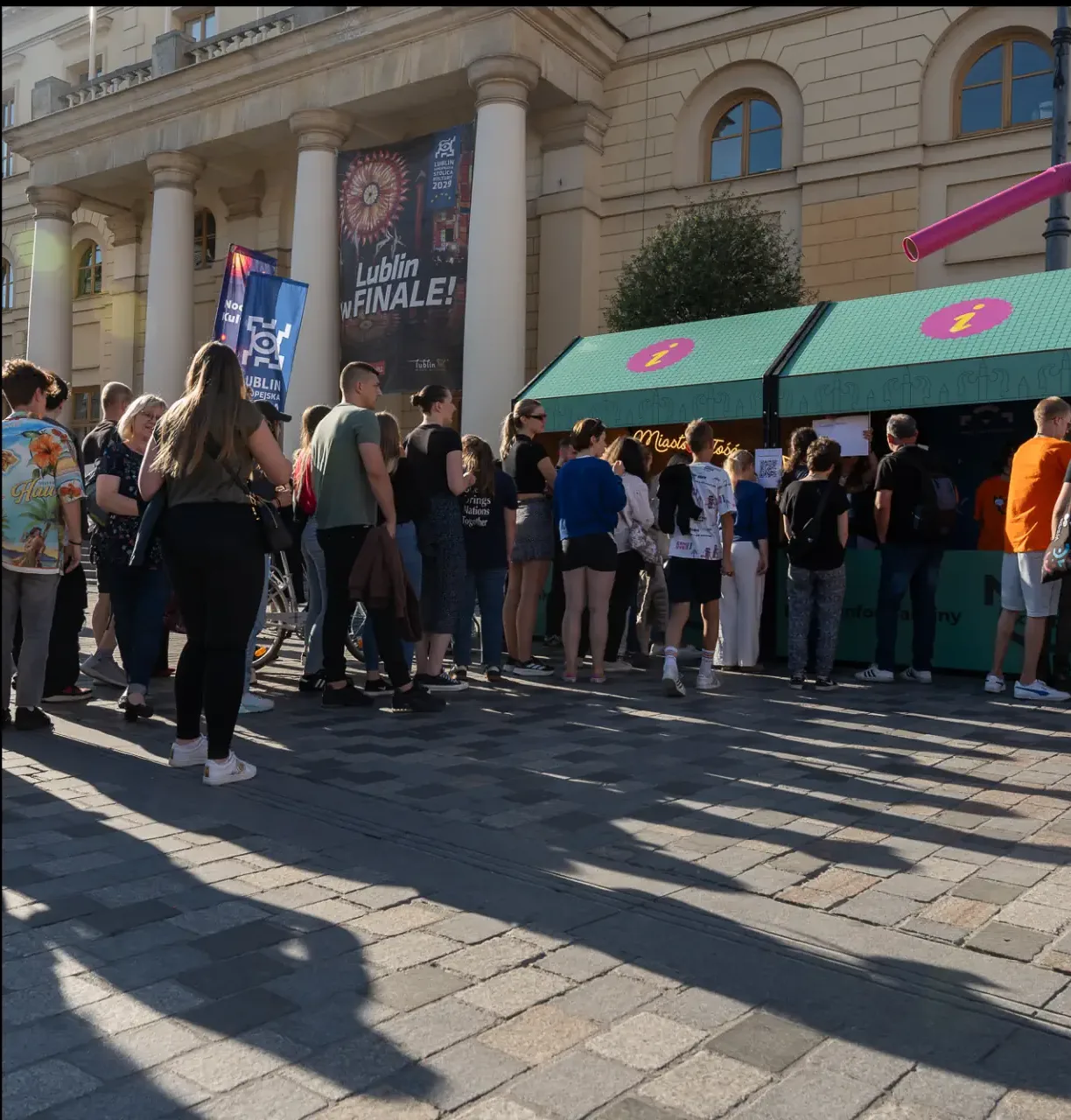Magdalena-Wojtas-Noc-Kultury-2024-43aaaa Tłum ludzi przy punkcie informacyjnym.